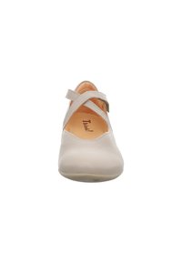 Helle beige Mary Jane-Schuhe aus Leder mit einem Kreuzriemen, abgerundeter Zehenpartie und gepolstertem Innensohle. Flache Gummisohle.