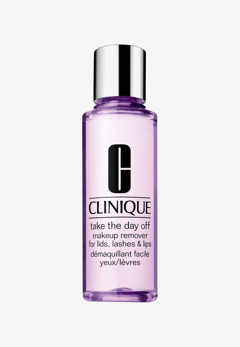 Clinique Take the Day Off make-up removing in een heldere paarse fles met een zilveren dop. De tekst op het etiket bevat productdetails en gebruiksinstructies.