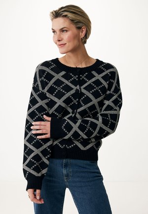 Knitted black and white cardigan featuring a diamond pattern, round neckline, button front, and ribbed cuffs and hem.