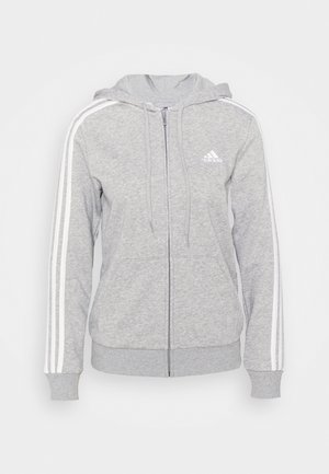 Hellgrauer Kapuzenpullover mit Reißverschluss, weißem Adidas-Logo auf der Brust, weißen drei Streifen entlang der Ärmel, Fronttaschen und Kordelzugkapuze.