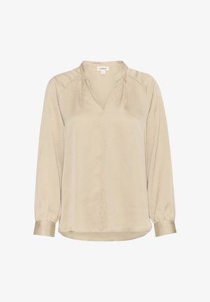 Beige Bluse mit langen Ärmeln und V-Ausschnitt, mit gerafften Schulternähten und Manschetten. Aus einem glatten, strukturierten Stoff gefertigt. Normale Passform.