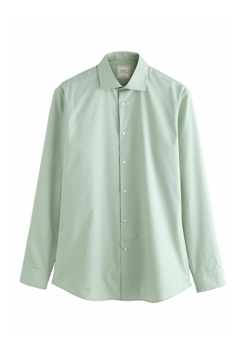 Chemise à manches longues vert clair en tissu lisse. Dotée d'un col pointu, d'une fermeture à boutons sur le devant et de poignets à un seul bouton. Sans motifs ni embellissements.