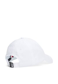 White baseball cap with a curved visor, adjustable strap at the back, and a small logo tag featuring red and navy accents on the strap.