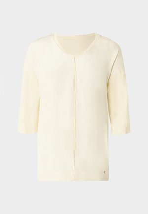 Svetlo rumena kratka majica z V-izrezom, ravnim krojem in subtilnim sijajem. V bližini roba ima majhen logotip blagovne znamke.