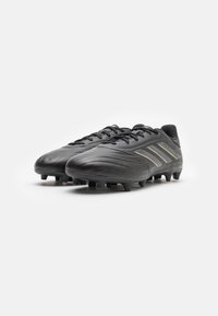 Black soccer cleats made of smooth synthetic material, featuring three gold stripes, standard lacing, and molded studs for grip.