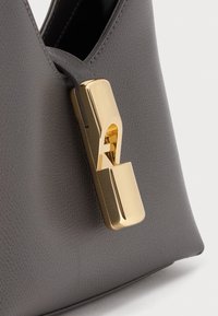 Gray leather handbag with a textured finish. Features a gold-tone clasp with a modern design and a smooth strap integration.