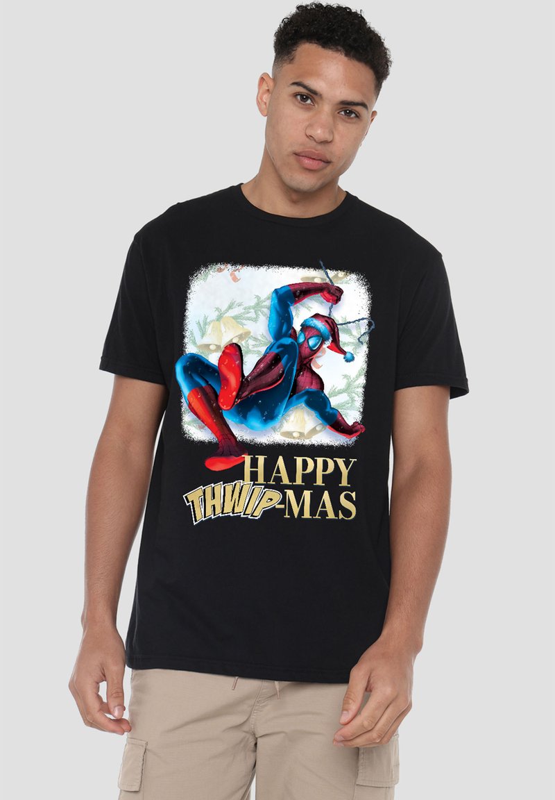 Young man wearing black t-shirt with Spider-Man in Santa hat swinging web and text "Happy THWIP-MAS" with festive bells background.