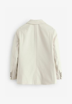 Sacou bej deschis cu un design croit, textură moale, rever cu decupaj și detalii cu nasturi pe mâneci. Vedere din spate.