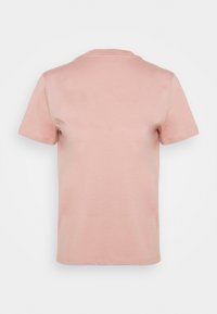 Camiseta de color rosa claro, de manga corta, confeccionada con algodón suave, que presenta un cuello redondo y una textura lisa con un diseño sencillo.