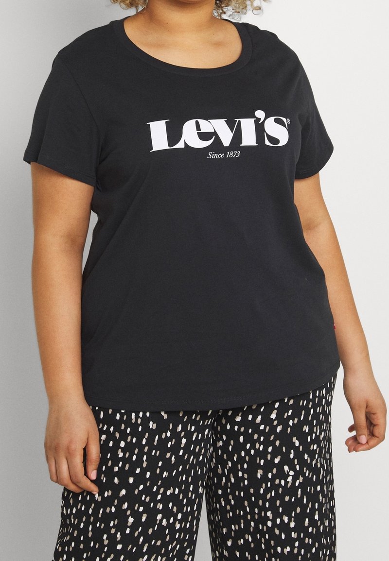 Camiseta de algodón negra con cuello redondo y mangas cortas, que presenta un logo blanco de "Levi's Desde 1873" en el frente.