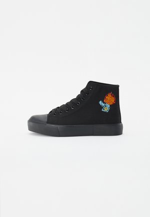 Black high-top sneakers made of canvas with a rubber toe cap, featuring an embroidered flame and lighter design on the side.