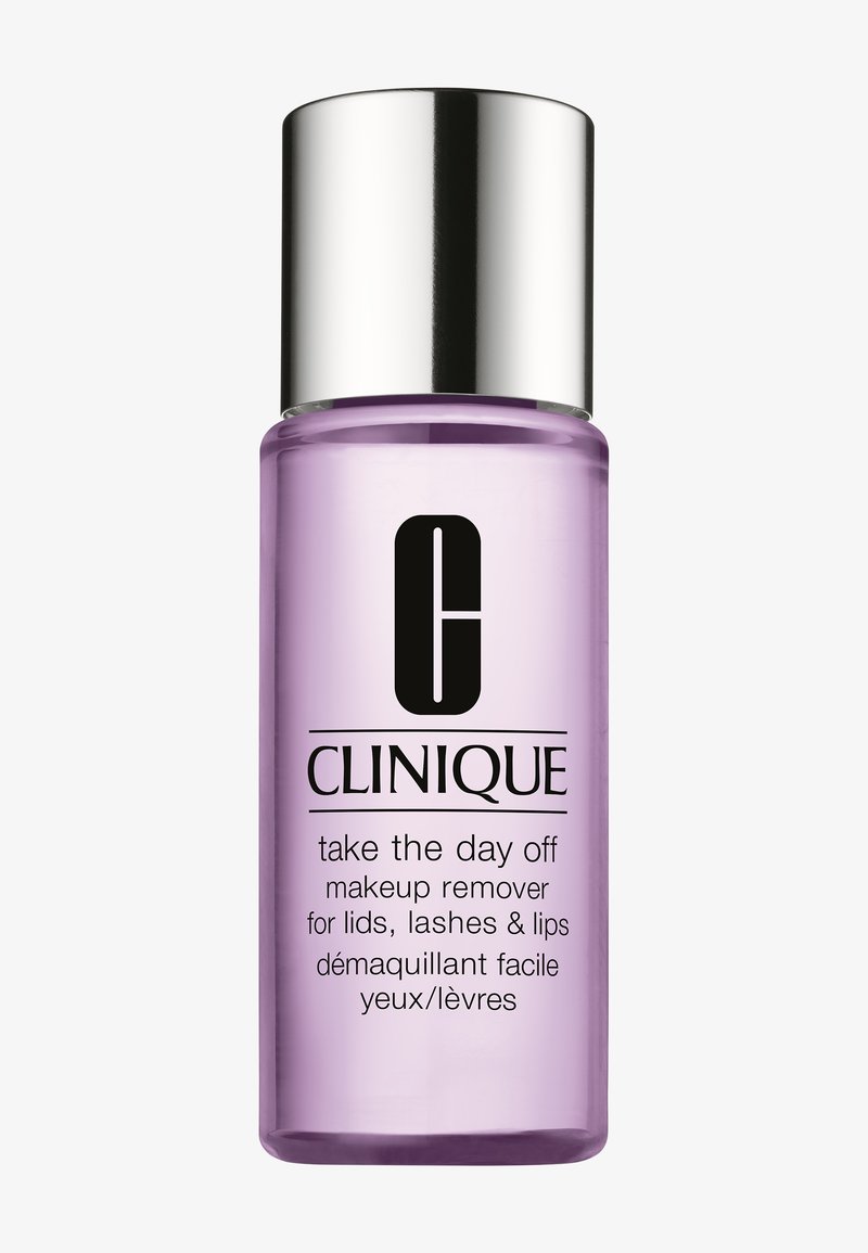 Démaquillant Clinique Take The Day Off dans une bouteille transparente et violette avec un bouchon argenté ; étiqueté pour une utilisation sur les paupières, les cils et les lèvres.