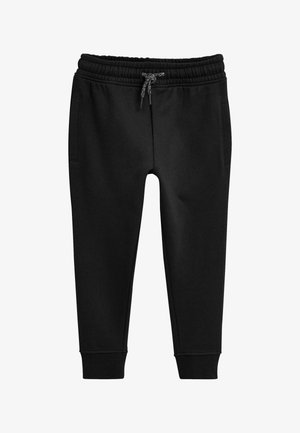 Pantalon de survêtement noir fuselé avec taille élastique, cordon réglable, poches latérales et chevilles bord-côtes.