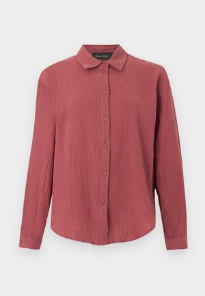 Chemise à manches longues texturée en rose poussiéreux avec col pointu et poignets boutonnés.
