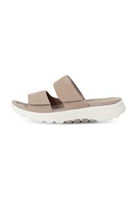 Beige suede slide sandals featuring two wide straps, cushioned footbed, and a white rubber outsole with textured grip.