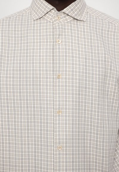 Button-up shirt in light beige with a checkered pattern, featuring small blue lines. Soft fabric with a classic collar and pearl buttons.