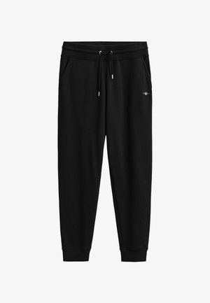 Schwarze, zulaufende Sweatpants mit elastischem Bund, Kordelzug, Seitentaschen, gerippten Bündchen und kleinem Logo am rechten Oberschenkel.