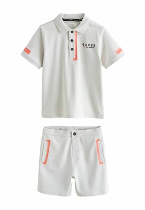 Short-sleeve white polo shirt with three buttons and black logo, paired with white shorts featuring pink accents and pockets.