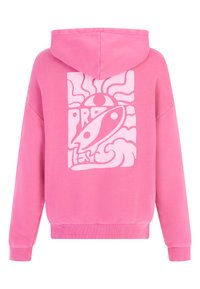 Sweat à capuche rose avec un grand motif graphique blanc comportant des éléments abstraits et du texte au dos. Tissu doux, coupe décontractée et poche kangourou.