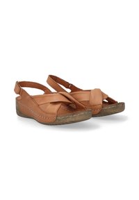 Sandaletten aus braunem Leder mit einem Kreuzdesign, einem Slingback-Riemen und einer strukturierten Keilsohle mit sichtbaren Nähdetails.