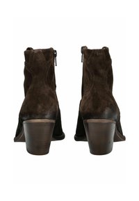 Brown suede ankle boots with a rounded toe, stacked heel, and decorative stitching. Side zippers for easy wear. Textured finish.