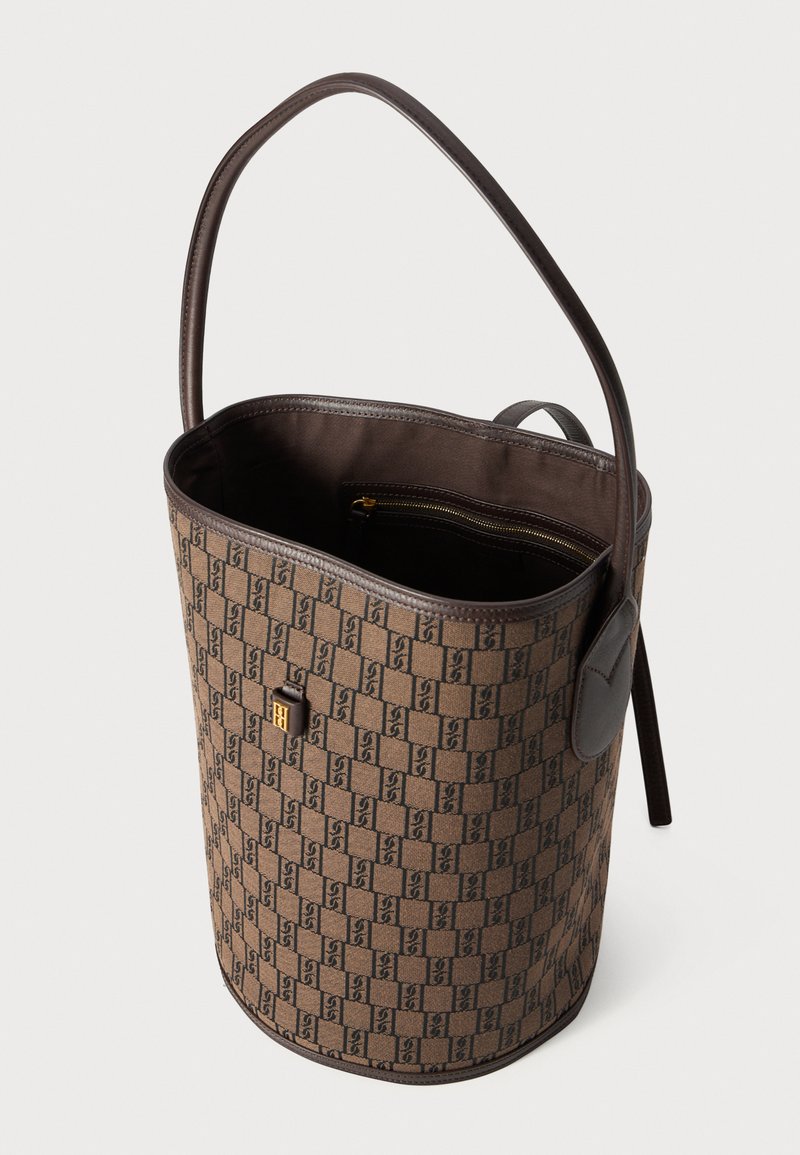Brown patterned bucket bag with an embossed logo, leather accents, and a zip pocket inside. Features a single shoulder strap.