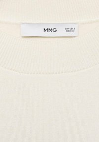 Cream-colored ribbed sweater with a round neckline and a label reading "MNG" in black. Soft texture, lightweight fabric. Size: Small.