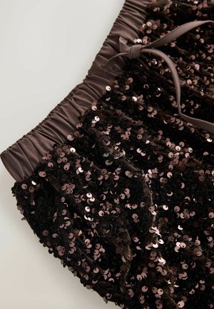 Black sequined fabric with a gathered, elastic waistband and satin ribbon detail. The sequins are round and shiny, creating a textured surface.