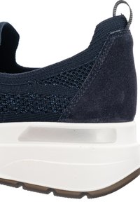 Navy blue knit sneaker heel with suede detail, pull tab, white thick sole, and textured brown rubber outsole.