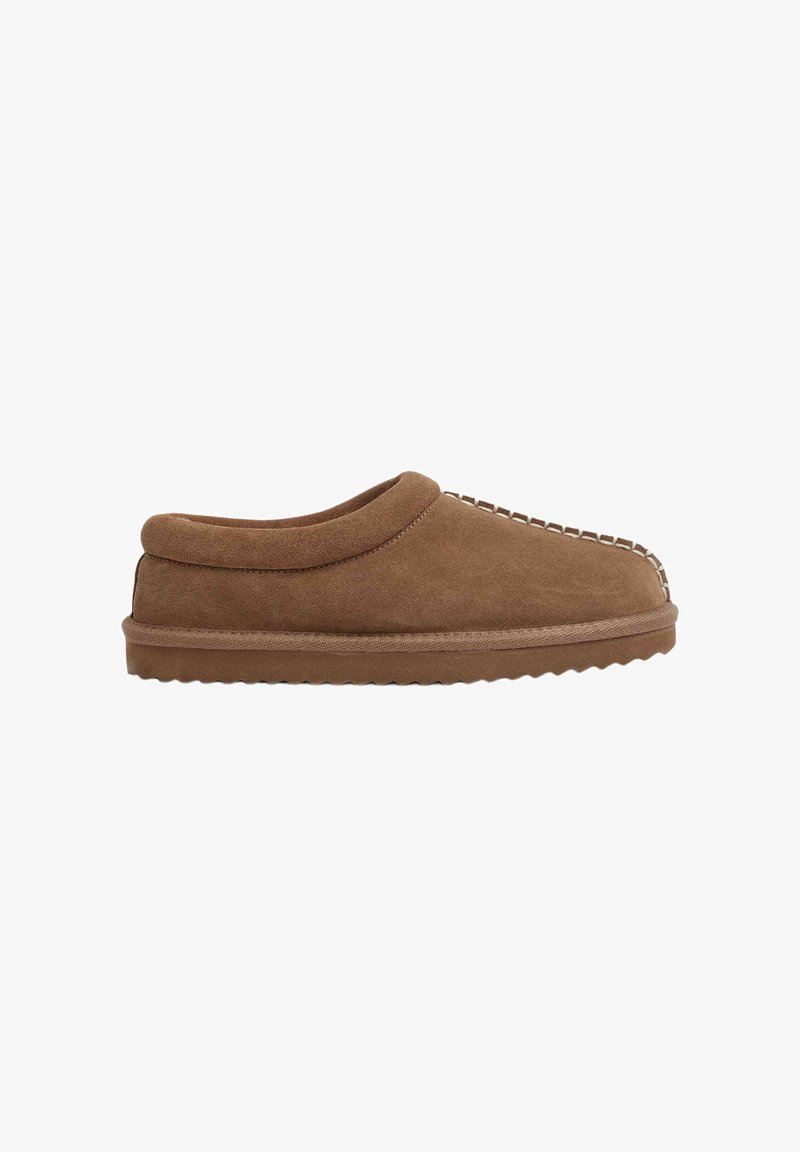 Brown suede slipper with a rounded collar, stitched accents along the front, and a textured, flexible rubber sole.