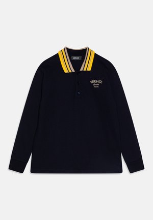 Polo de manga larga en color marino con cuello a rayas amarillas y beige, con una tapa de dos botones y logo bordado en el pecho.