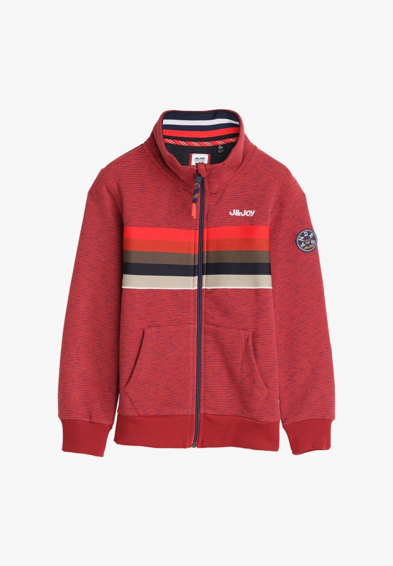 Rode ritsjack met horizontale strepen in tinten oranje, bruin en marineblauw. Heeft een hoge kraag, twee zakken aan de voorkant en geribbelde manchetten.