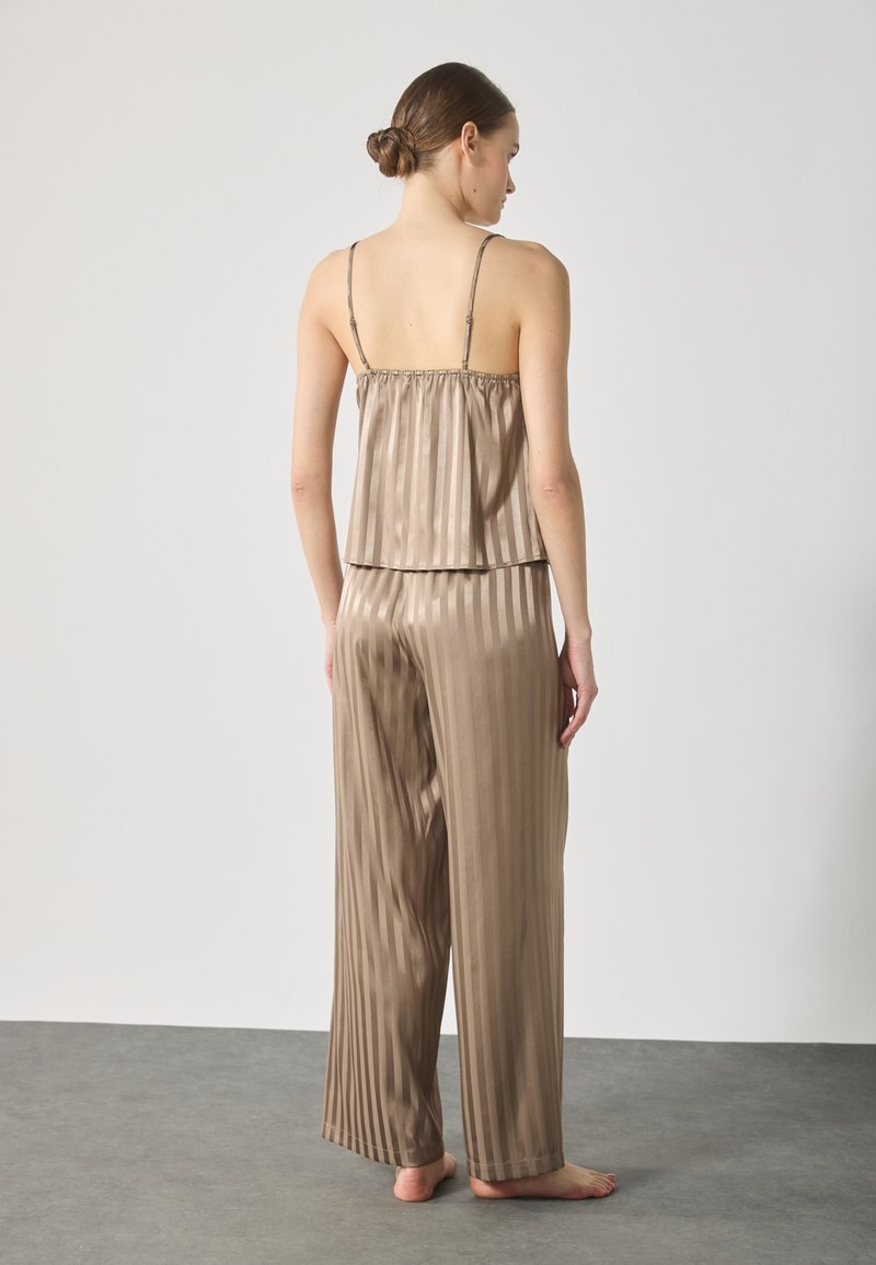 Ensemble de pyjama en satin taupe, comprenant un caraco plissé avec des bretelles spaghetti et un pantalon large assorti, tous deux bénéficiant d'une texture douce.