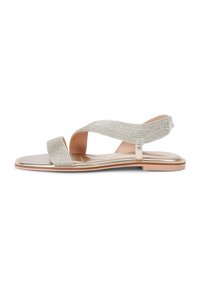 Silver sandals with a flat sole, featuring a wide, textured strap crossing over the foot, and a simple ankle strap for support.