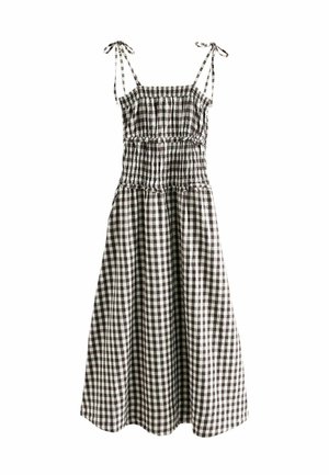 Schwarz-weiß kariertes ärmelloses Midikleid mit gerafftem Oberteil und bindbaren Schulterträgern.