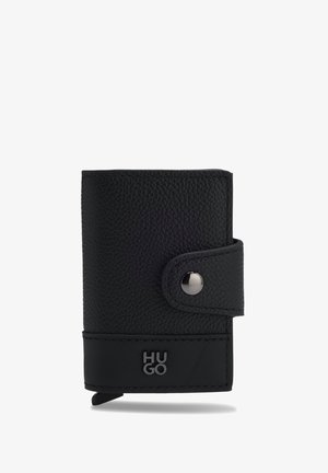 Black textured leather wallet with snap-button strap closure and silver "HUGO" logo on the lower front panel.