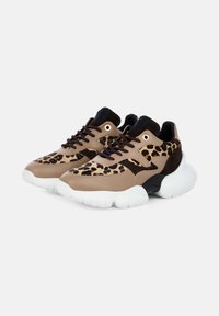 Pair of chunky sneakers with leopard print panels, tan leather and dark brown suede, black laces, and thick white soles on a light background.