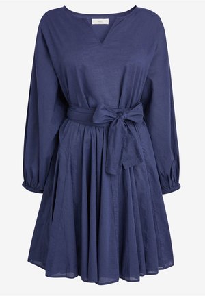 Robe bleu marine à manches longues, encolure ronde, jupe plissée et large ceinture en tissu nouée en nœud à la taille.