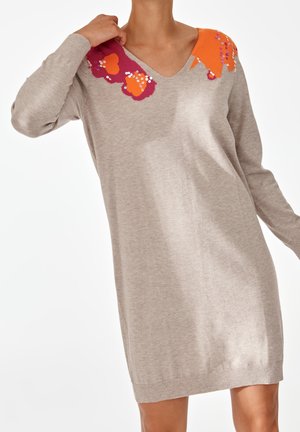 Beiges Strickkleid mit V-Ausschnitt, langen Ärmeln und leuchtend orange- und magentafarbener Blumenstickerei mit Pailletten auf den Schultern.