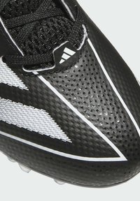 Scarpina da calcio nera con superficie texturizzata, accenti bianchi e perforazioni, dotata di un sistema di allacciatura centrale e di una suola robusta.