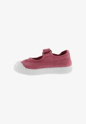 Zapato infantil de lona rosa con suela y puntera de goma blanca, con una tira de velcro en la parte superior.