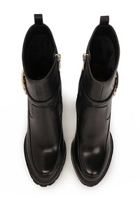 Black leather ankle boots with a smooth finish, silver zippers on the sides, and a chunky sole; features a rounded toe and textured lining.