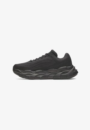 Black athletic shoe with a textured mesh upper, padded collar, and thick, wavy outsole for cushioning. Minimalistic design with tonal accents.
