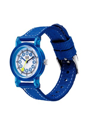 Reloj de pulsera azul con correa de tela, esfera blanca con números azules, manecillas negras de horas y minutos, y una manecilla amarilla de segundos que marca las 10:10:35.