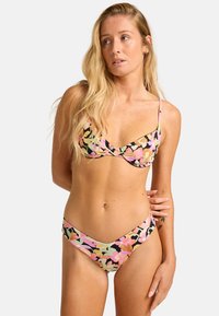 Floral bikini set featuring a black background with pink, orange, and green flowers. Soft fabric, triangular cups, and low-rise fit.