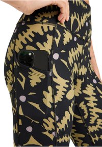 High-waisted leggings in black with a yellow and pink abstract pattern. Features a side pocket holding a smartphone, with visible stitching detail.