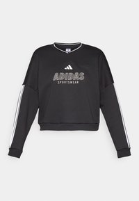 Crni Adidas sportski dukserica s bijelim logotipom i bočnim trakama, s opuštenim krojem i V-izrezom.