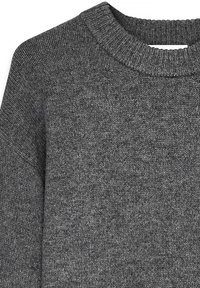 Gray knit sweater featuring a ribbed crew neckline, textured fabric, and a relaxed fit. The material appears soft and thick.