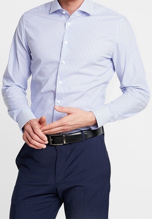Modrá a bílá pruhovaná košile s dlouhým rukávem, s knoflíkovým zapínáním a širokým límcem, v kombinaci s tmavě modrými formálními kalhotami a černým opaskem.