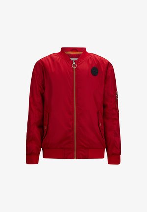 Red bomber jacket made of smooth, shiny fabric. Features a gold zipper, ribbed cuffs, and hem, with a round black logo on the chest.